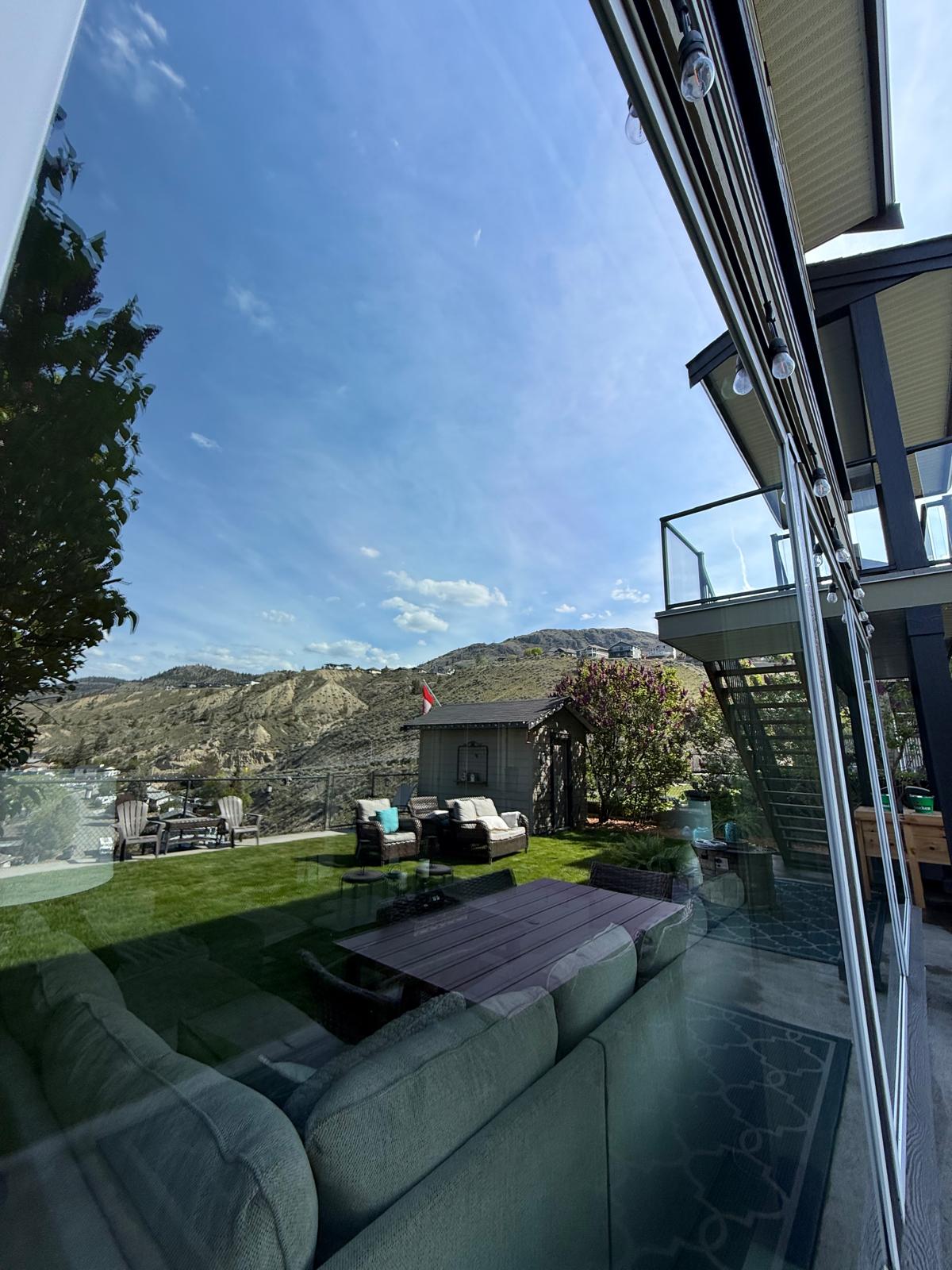 Window cleaner finishing a streak-free pane on a Kamloops home
